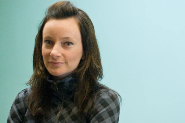 a lady looking towards the camera with long brown hair