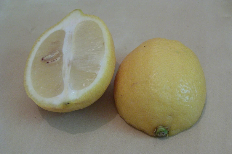 an orange and an lemon on top of each other