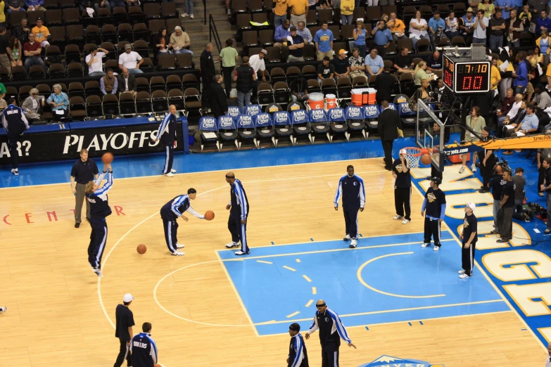 the basketball players are playing on the court