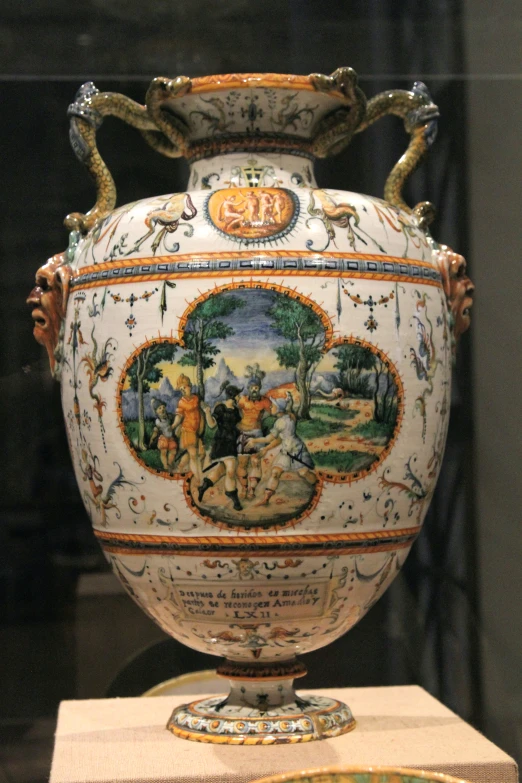 a decorative vase on display with art work