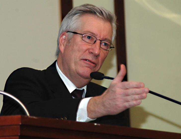 an older man giving a speech to a group