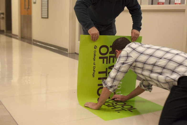 a man is laying on an object and looking at another man