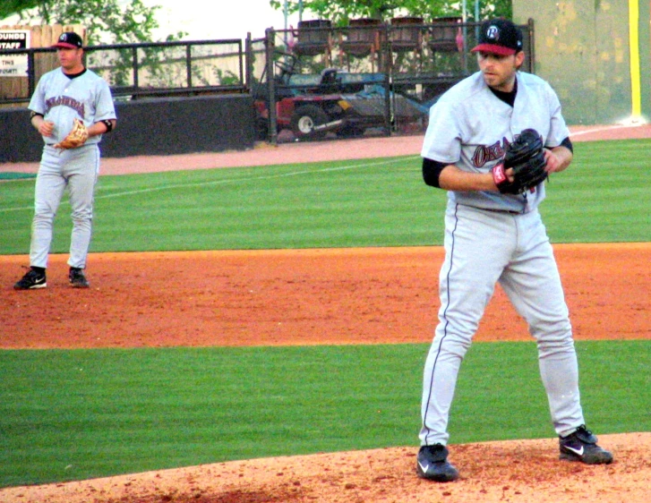 two baseball players on a baseball field getting ready to play