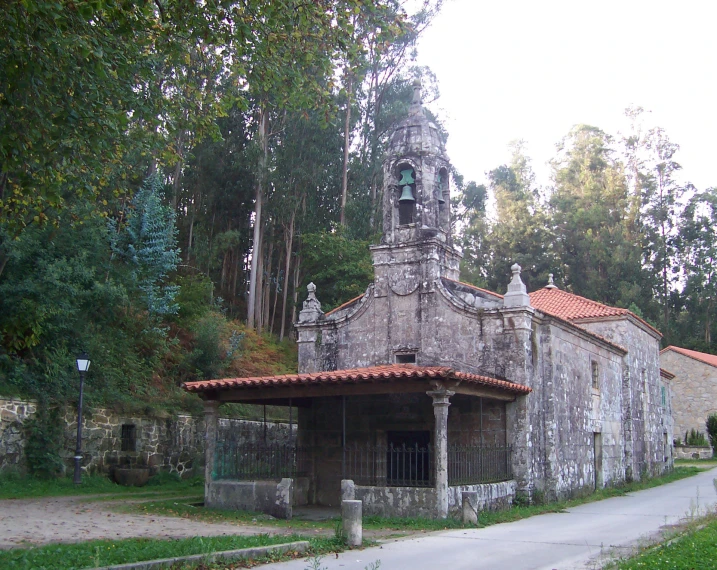 an old church with a stone tower and stained glass windows