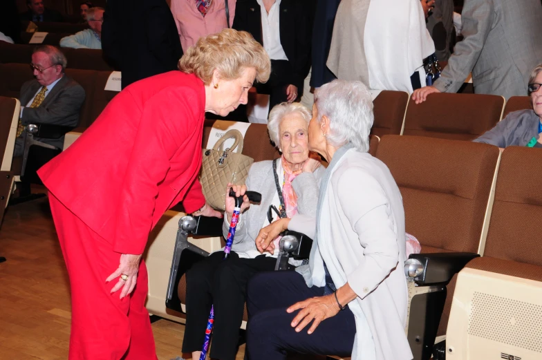 an elderly woman gets help with her projector