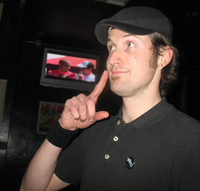 a man pointing at the camera with his finger