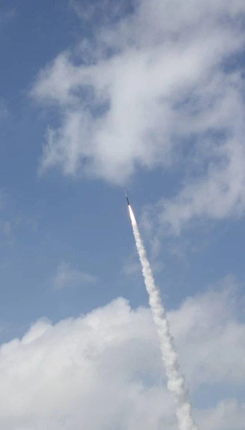 a rocket is seen in the sky with a long tail