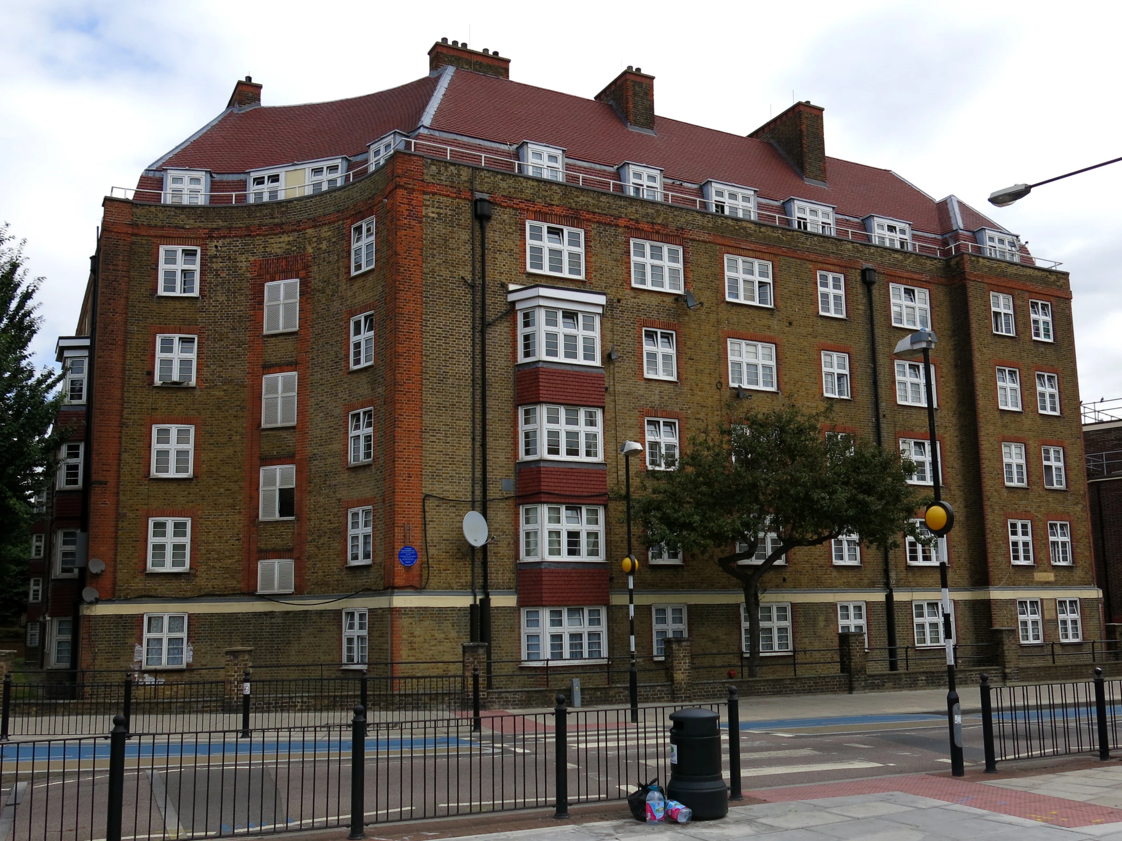 a large building sitting next to some cars on a street