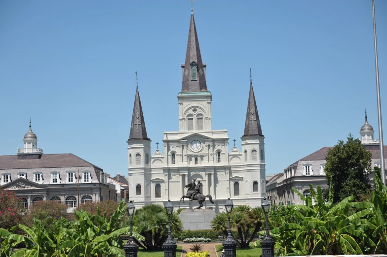 an ornate white cathedral in the background of greenery