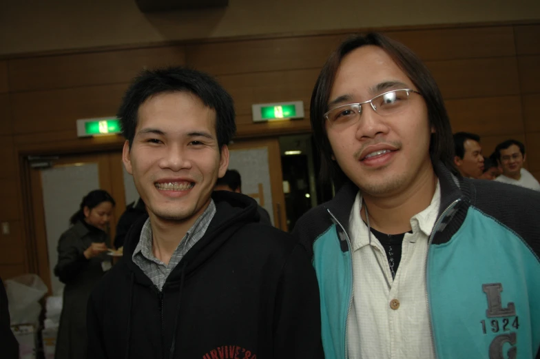 two men standing side by side smiling for the camera