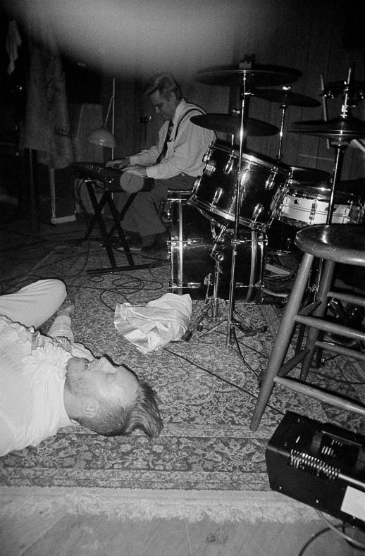 a group of people playing on a rug by some guitars