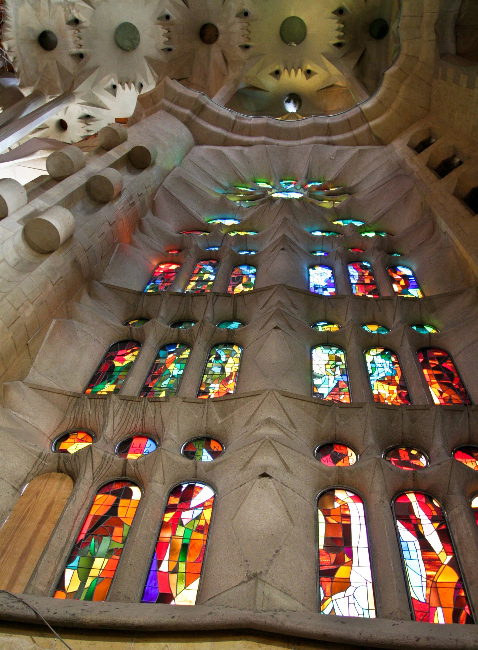 the interior of a cathedral with various stained glass windows