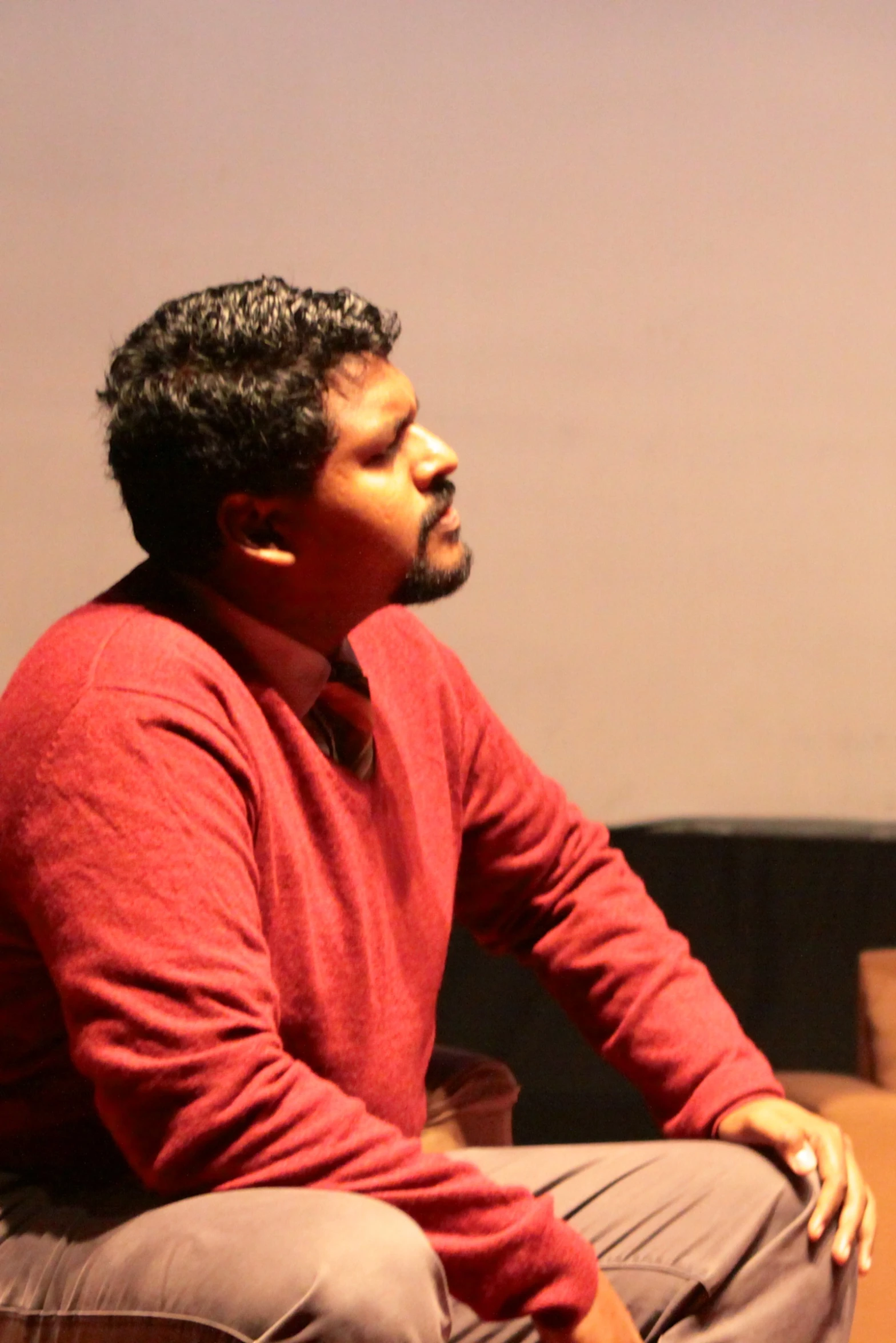 a man sitting on a chair in front of a light