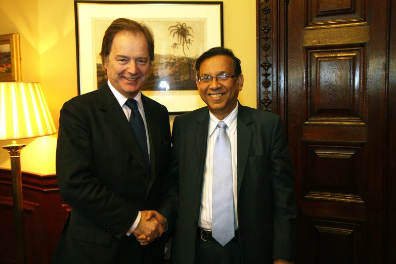 two men standing side by side near a room