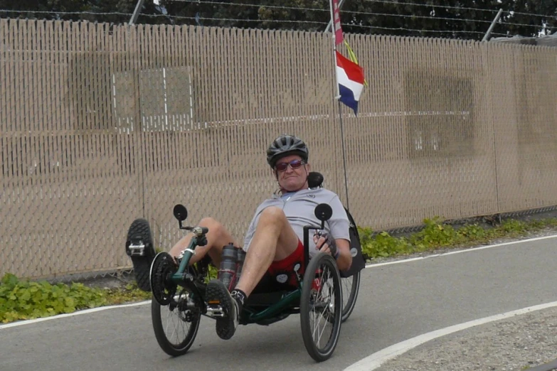 a man in a wheelchair driving down the street