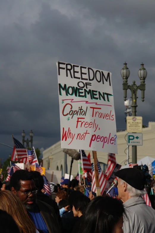 people hold up signs and walk down the street