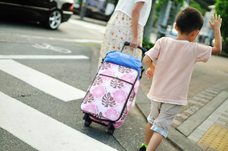 a woman and her child crossing the street