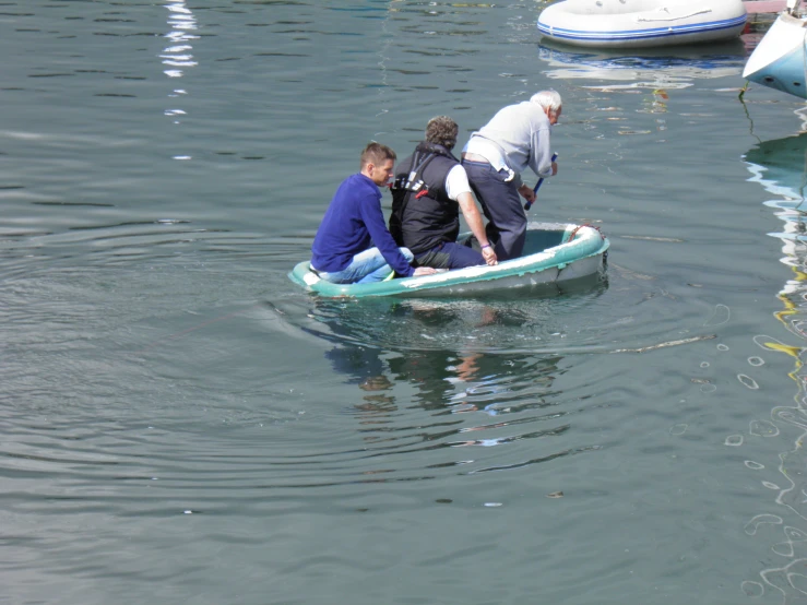 two men sitting in the center of a small boat