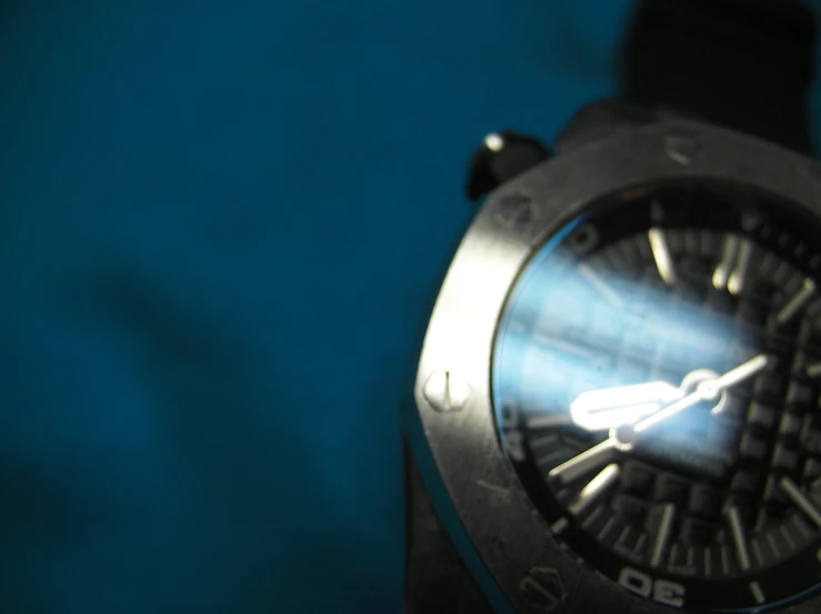 this is an image of a watch that is on a blue surface