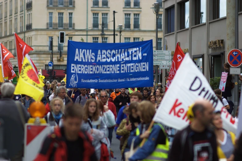 people are walking in a protest on the street