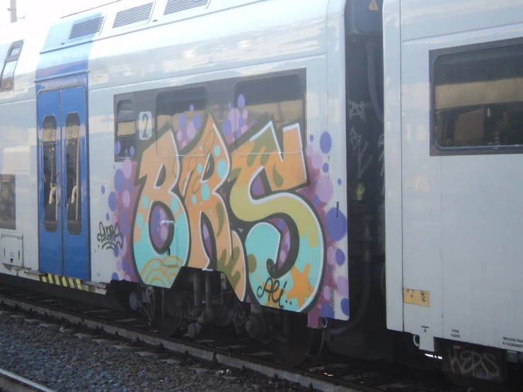 the front of a subway train with graffiti on it