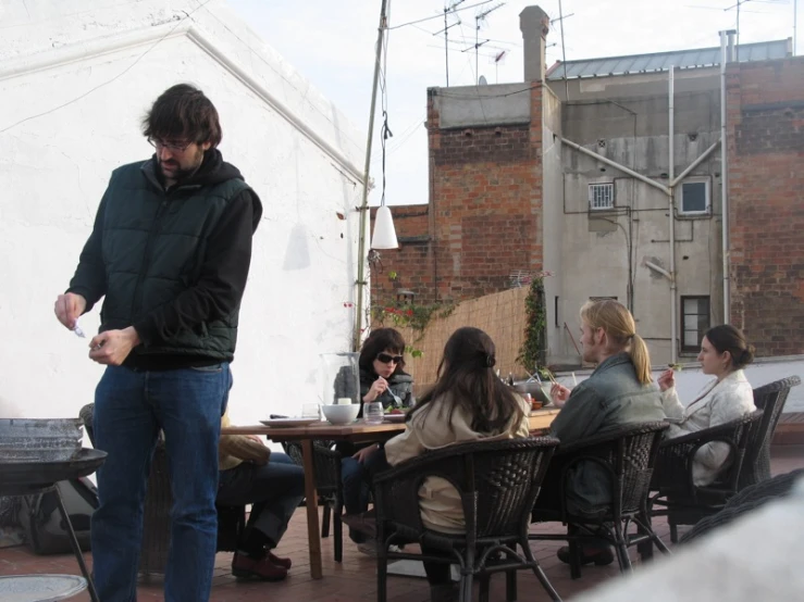 a person with a metal cane standing near some tables and chairs