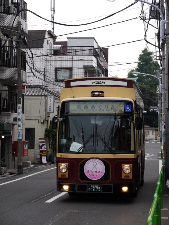 there is a brown bus that has pink signs on it