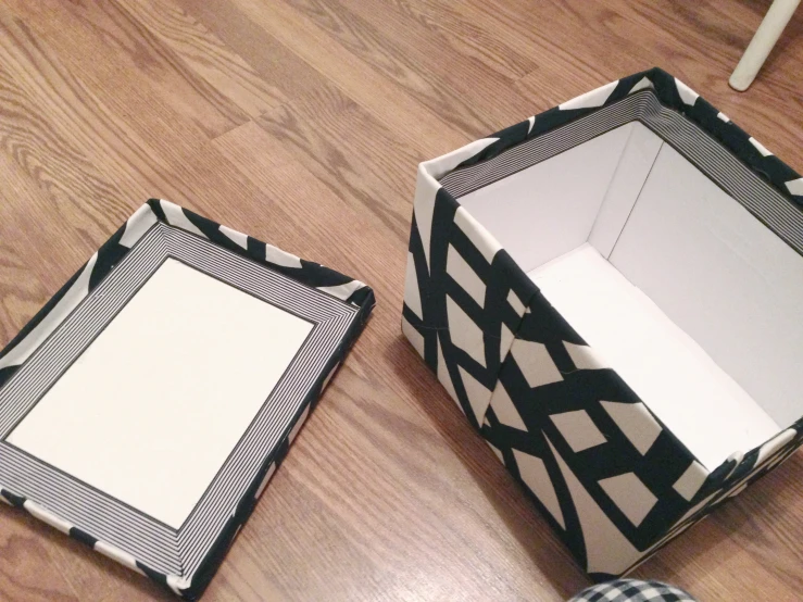 an opened box on the floor by another open box