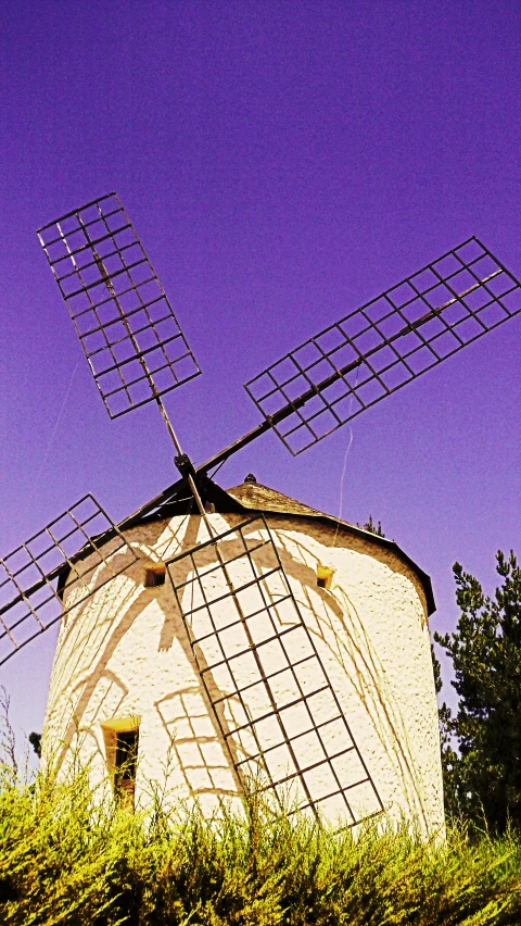 the two windmills are on top of the hill