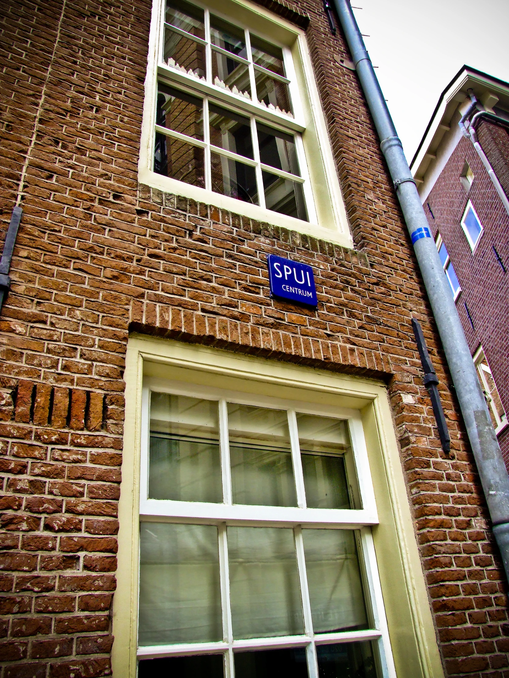 a tall brick building sitting next to a street