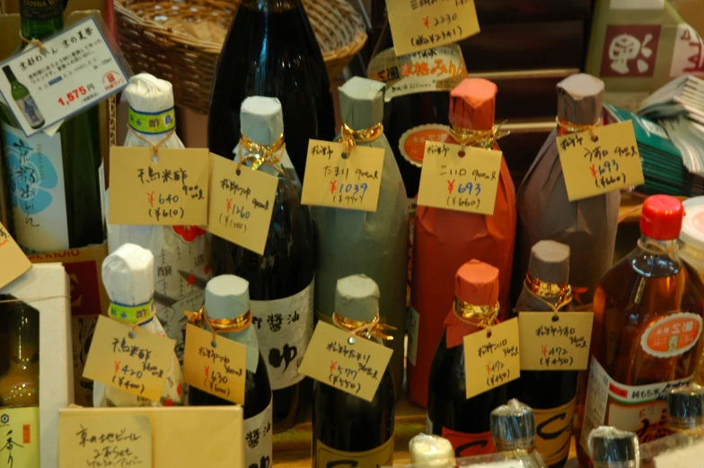 many bottles with paper note tags attached to them