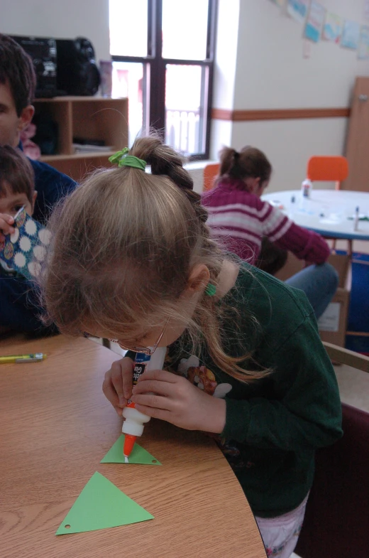 a  is looking at a construction paper