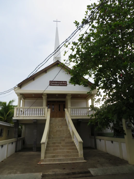 a small wooden church with stairs leading up the front