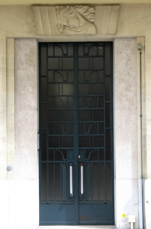 a black front door is flanked by two pillar pillars