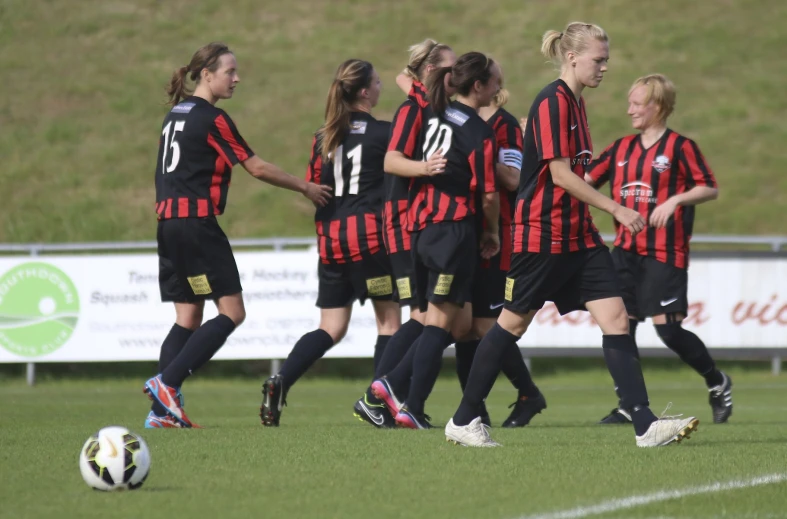 there are many women playing soccer against each other