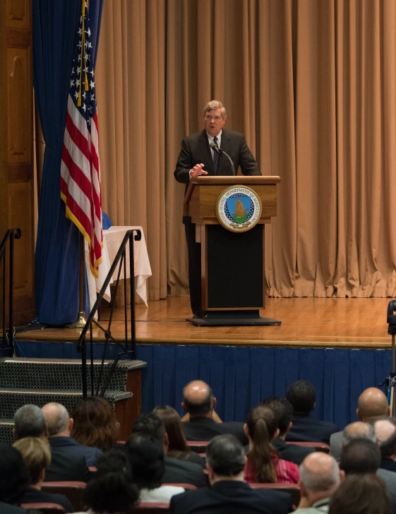 the president is giving a speech to an audience