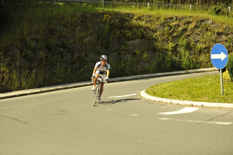 a cyclist riding on the street in a bicyclist uniform