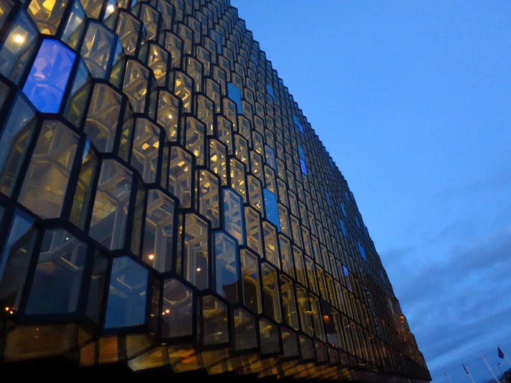 the corner of an old building with many windows lit up at night