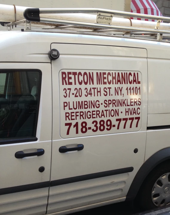 a van for a plumbing firm sitting in a street