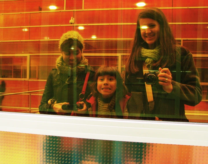 a woman taking a selfie with two other women