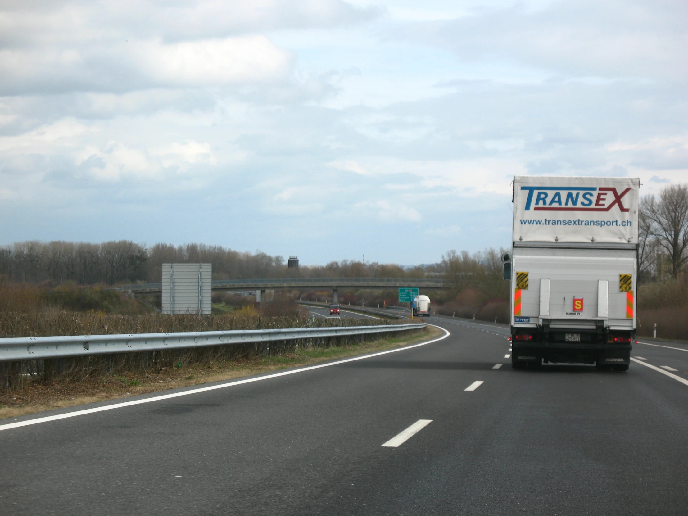 an eighteen wheeler truck driving down the highway