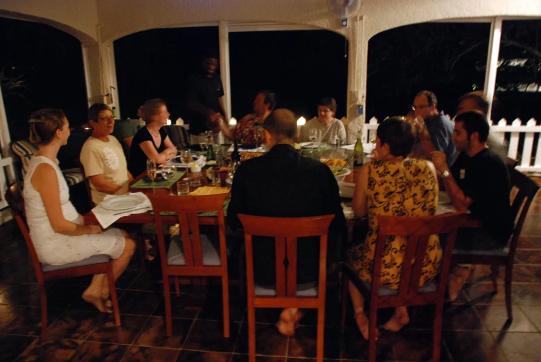 people sitting at a table with plates of food