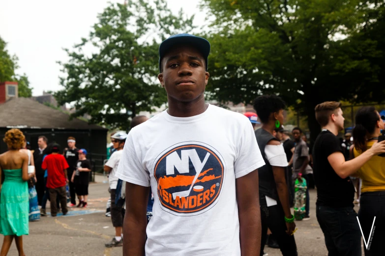 a man stands with several others in the background