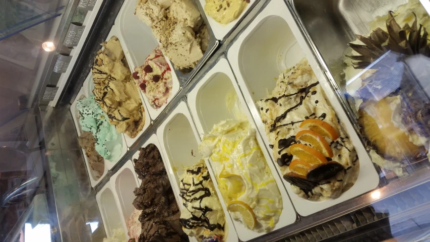 display case in an ice cream parlor filled with different types of ice cream