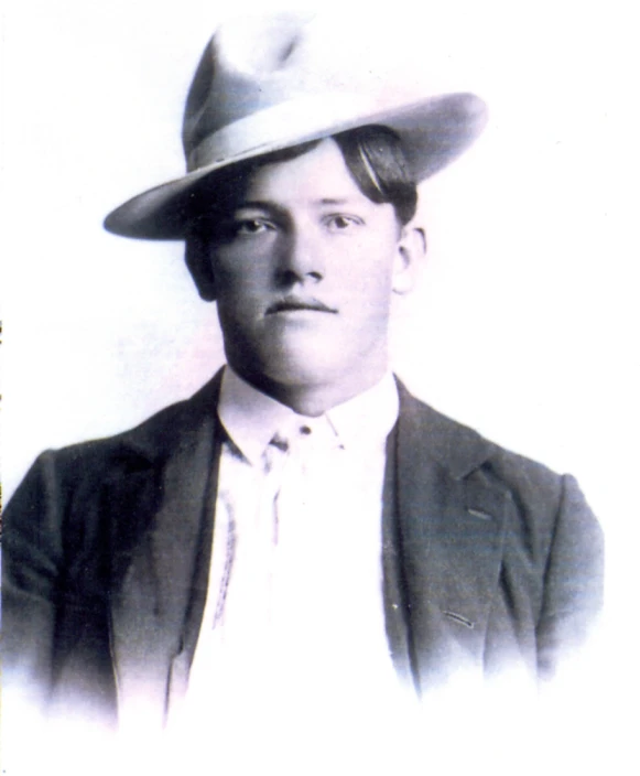 black and white pograph of young man with hat on