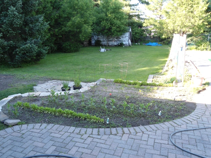 a backyard with a raised garden bed and patio