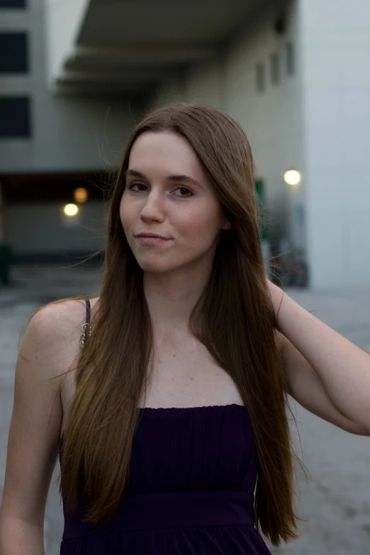 woman in purple dress standing in parking lot