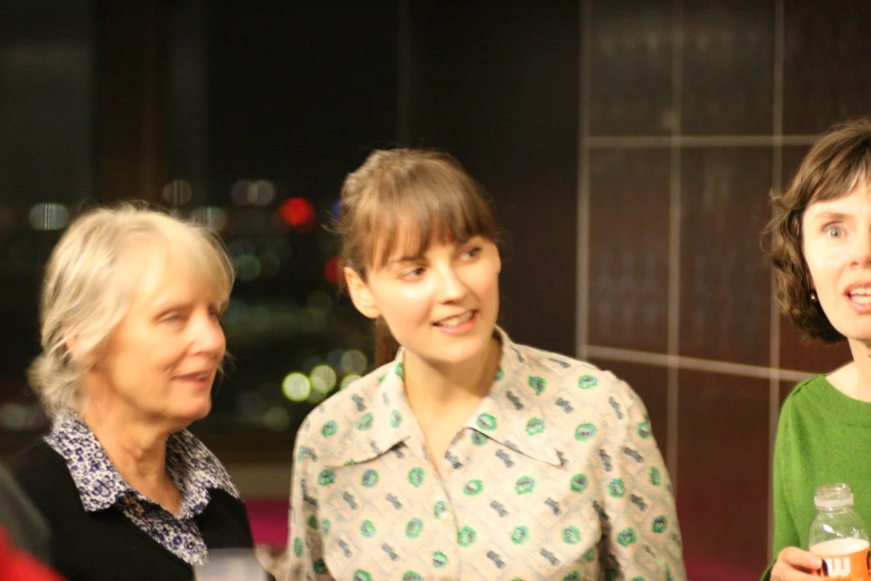 three women standing in a building at night