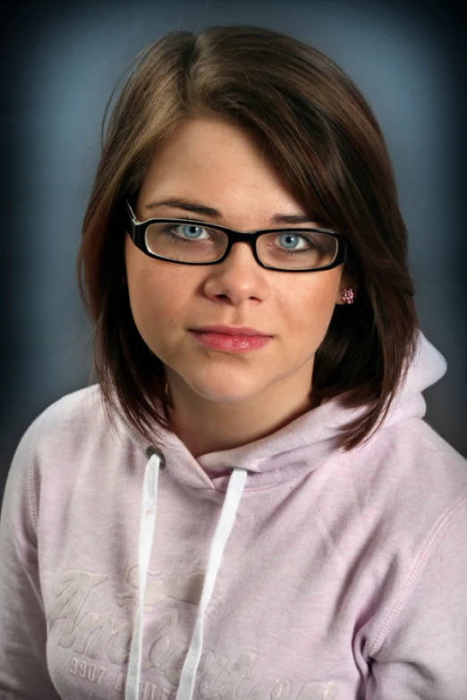 a woman wearing glasses posing for the camera
