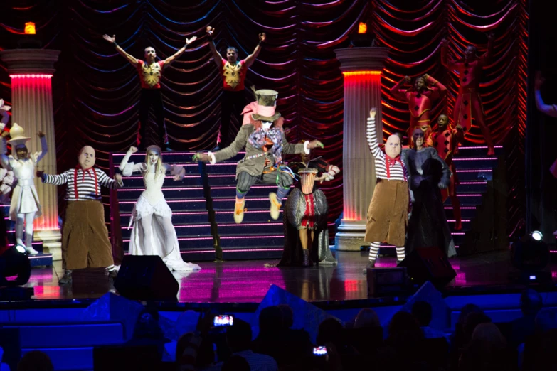 performers are dressed in costumes on stage